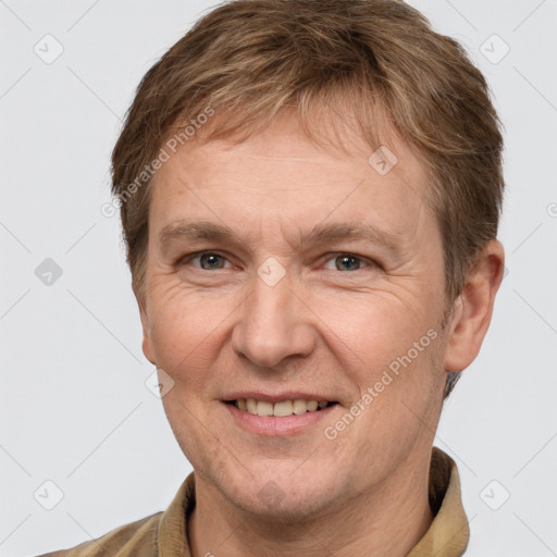 Joyful white adult male with short  brown hair and grey eyes