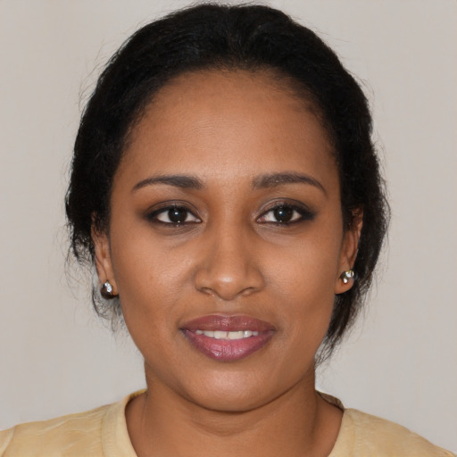 Joyful black young-adult female with medium  brown hair and brown eyes