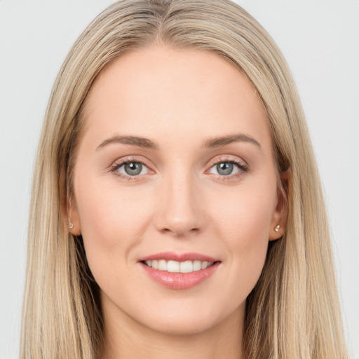 Joyful white young-adult female with long  brown hair and grey eyes