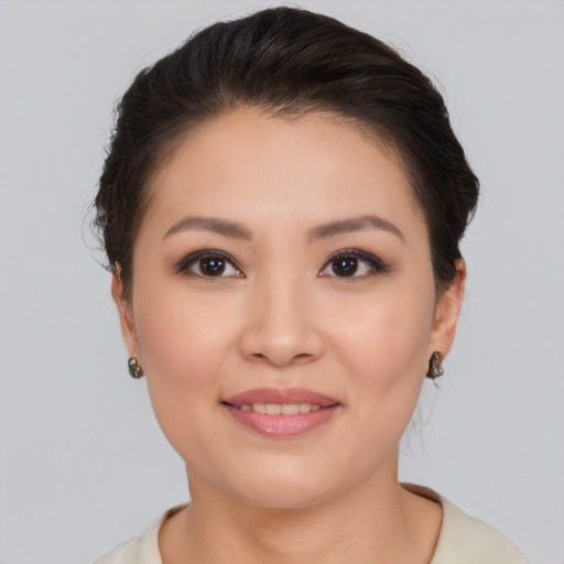 Joyful asian young-adult female with medium  brown hair and brown eyes