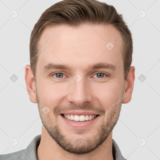 Joyful white young-adult male with short  brown hair and grey eyes