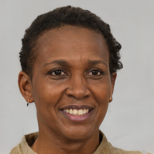 Joyful black adult female with short  brown hair and brown eyes