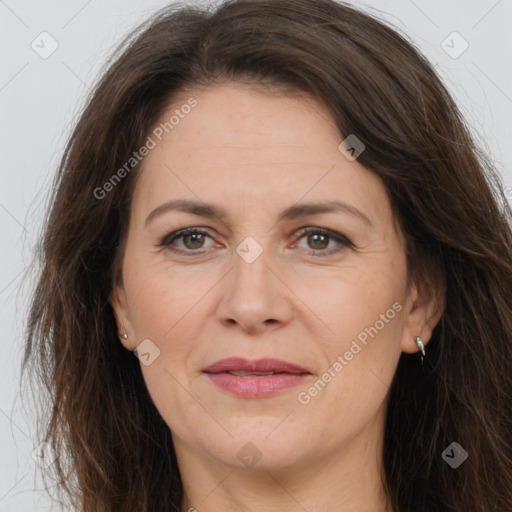 Joyful white adult female with long  brown hair and brown eyes