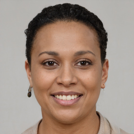 Joyful latino young-adult female with short  black hair and brown eyes