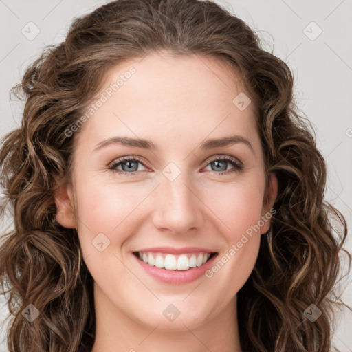 Joyful white young-adult female with long  brown hair and green eyes