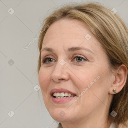 Joyful white adult female with long  brown hair and blue eyes