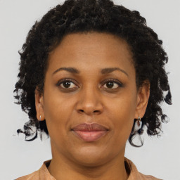 Joyful black adult female with short  brown hair and brown eyes