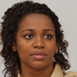 Neutral black young-adult female with medium  brown hair and brown eyes