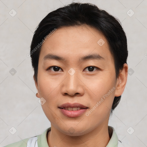 Joyful asian young-adult male with short  black hair and brown eyes