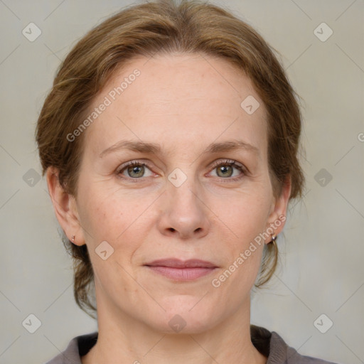 Joyful white adult female with medium  brown hair and blue eyes