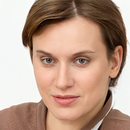 Joyful white young-adult female with short  brown hair and blue eyes