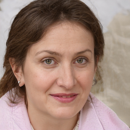 Joyful white adult female with medium  brown hair and blue eyes