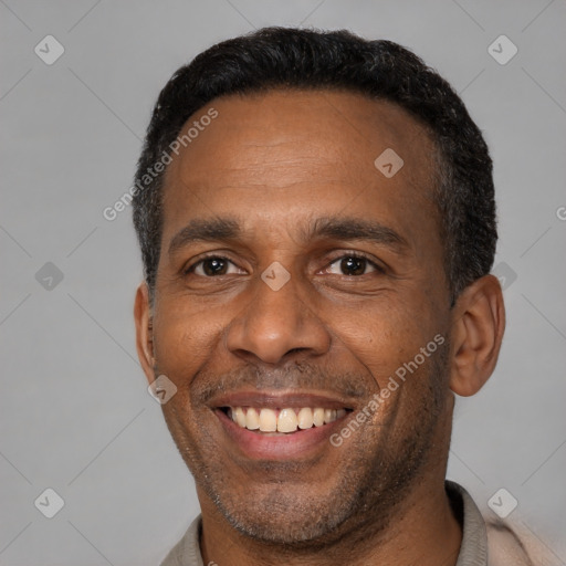 Joyful latino adult male with short  black hair and brown eyes