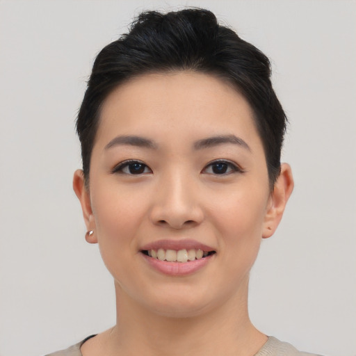 Joyful asian young-adult female with short  black hair and brown eyes