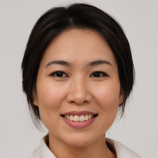 Joyful white young-adult female with medium  brown hair and brown eyes