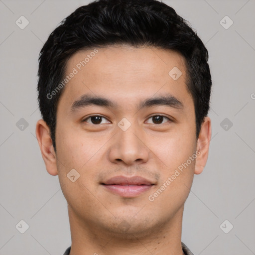 Joyful asian young-adult male with short  black hair and brown eyes