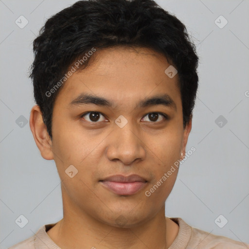 Joyful latino young-adult male with short  brown hair and brown eyes