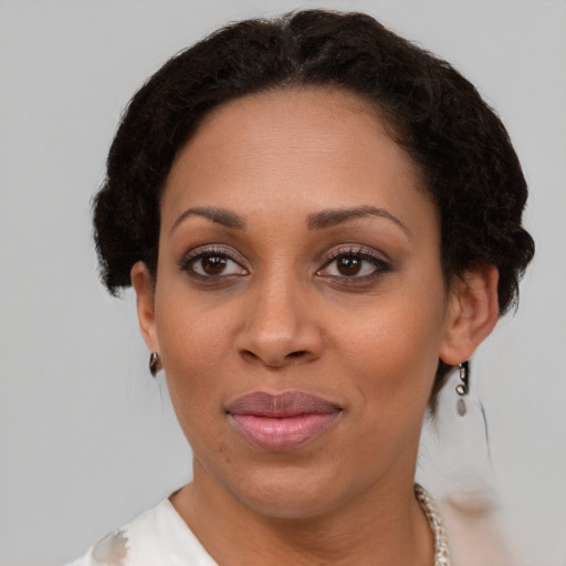 Joyful latino adult female with short  brown hair and brown eyes