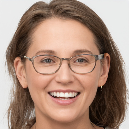 Joyful white adult female with medium  brown hair and blue eyes