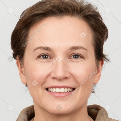 Joyful white adult female with short  brown hair and grey eyes