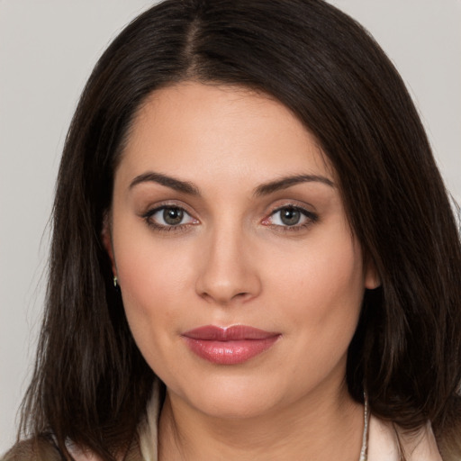 Joyful white young-adult female with medium  brown hair and brown eyes