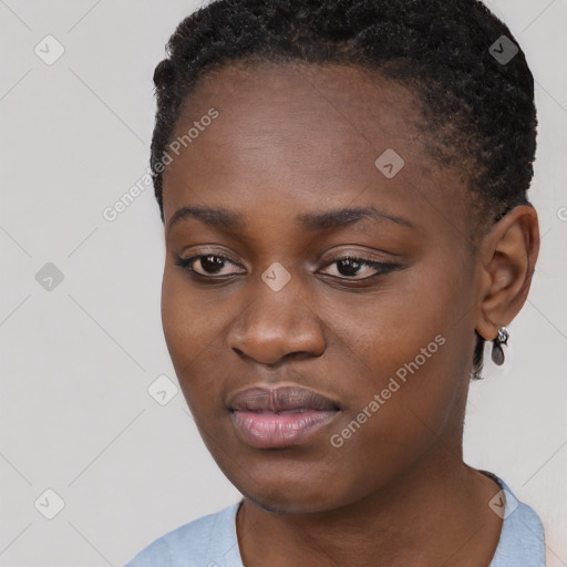 Joyful black young-adult female with short  black hair and brown eyes