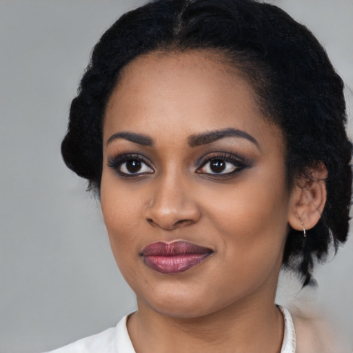 Joyful black young-adult female with medium  black hair and brown eyes