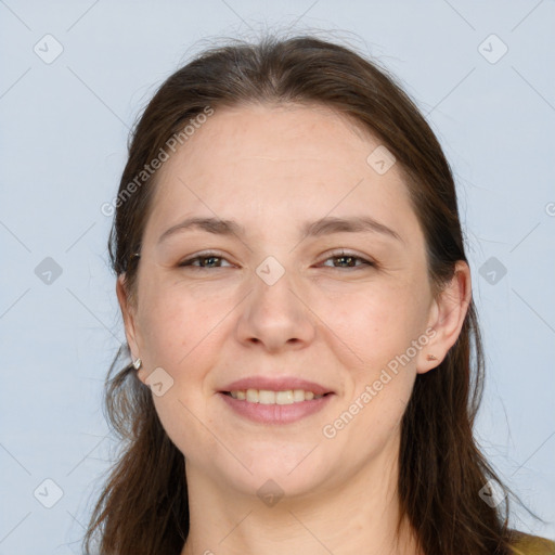 Joyful white adult female with long  brown hair and brown eyes