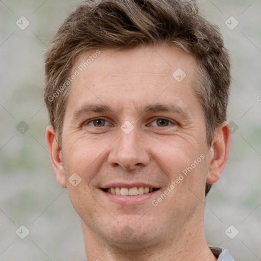 Joyful white adult male with short  brown hair and grey eyes