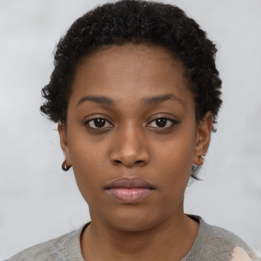 Neutral black young-adult female with short  black hair and brown eyes