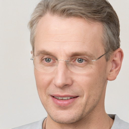 Joyful white adult male with short  brown hair and grey eyes