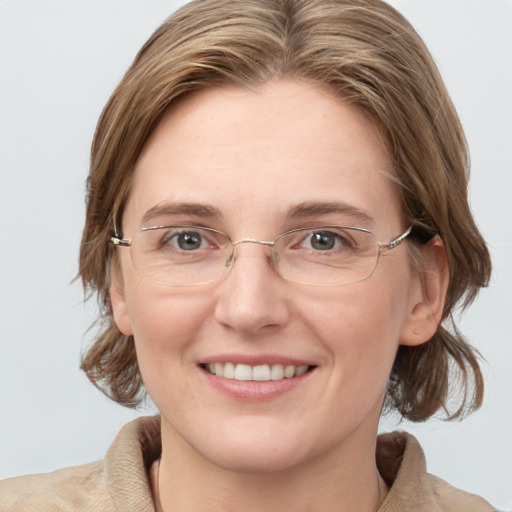 Joyful white adult female with medium  brown hair and grey eyes