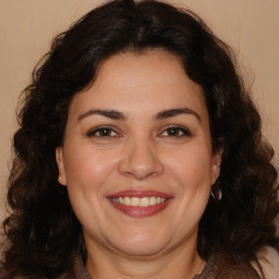 Joyful white adult female with long  brown hair and brown eyes