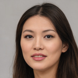 Joyful asian young-adult female with long  brown hair and brown eyes