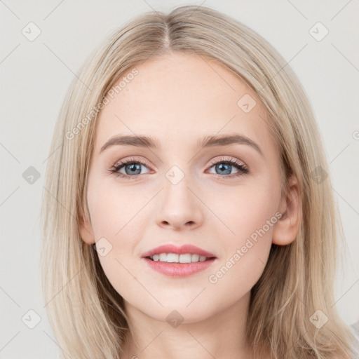 Joyful white young-adult female with long  brown hair and blue eyes