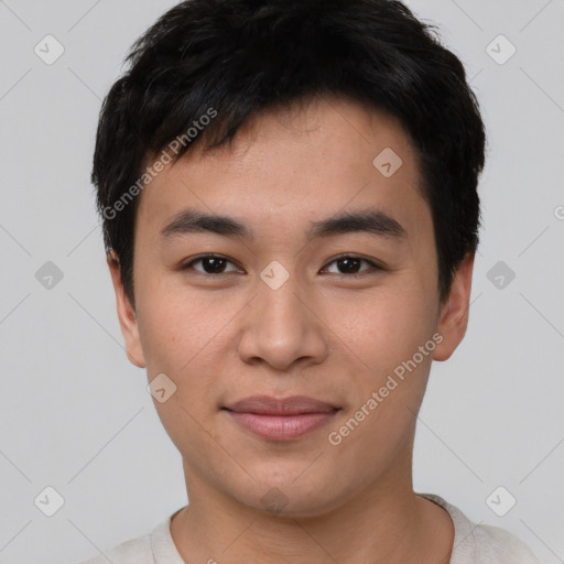 Joyful asian young-adult male with short  brown hair and brown eyes