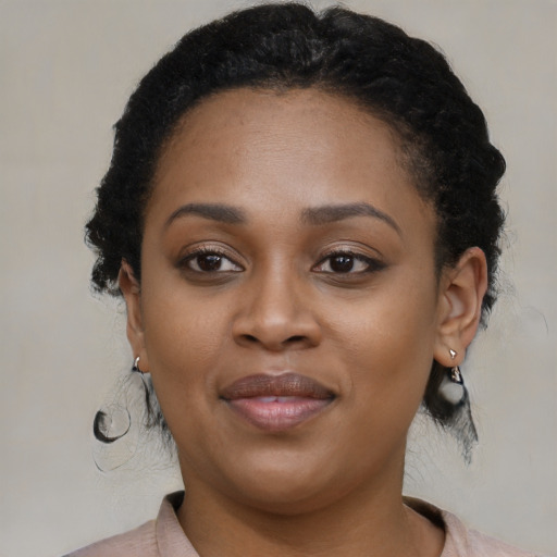 Joyful black young-adult female with medium  black hair and brown eyes