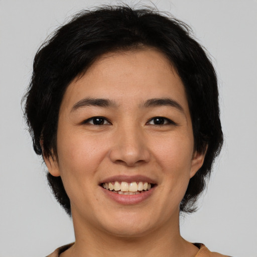 Joyful white young-adult female with medium  black hair and brown eyes