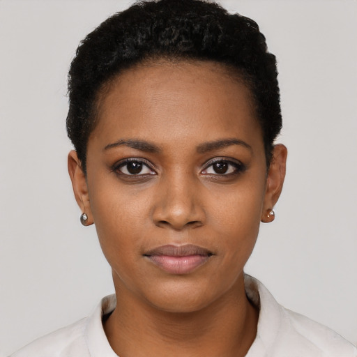 Joyful black young-adult female with short  black hair and brown eyes