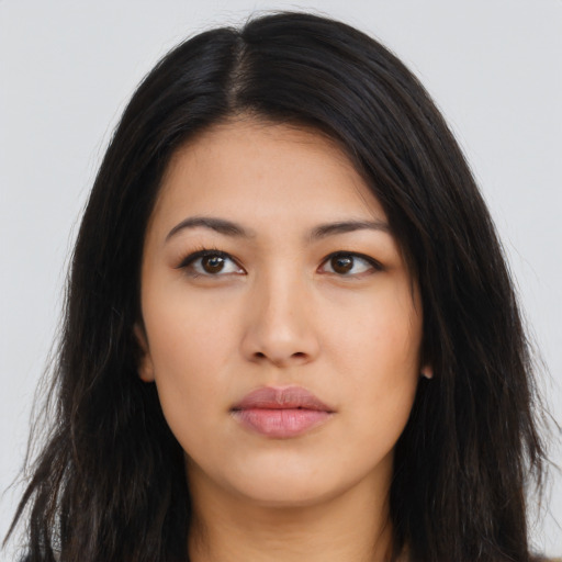 Neutral latino young-adult female with long  brown hair and brown eyes