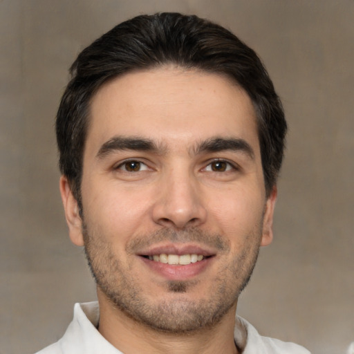 Joyful white young-adult male with short  brown hair and brown eyes