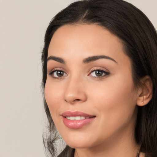 Joyful white young-adult female with long  black hair and brown eyes