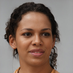 Joyful latino young-adult female with medium  brown hair and brown eyes