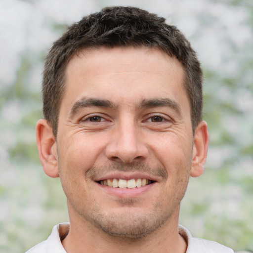 Joyful white young-adult male with short  brown hair and brown eyes