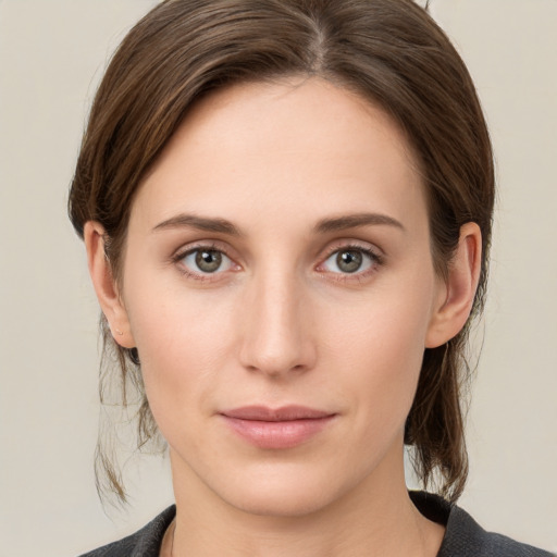 Joyful white young-adult female with medium  brown hair and grey eyes