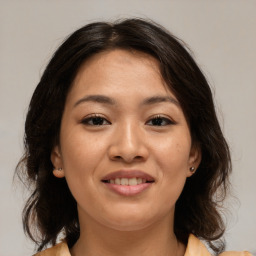 Joyful asian young-adult female with medium  brown hair and brown eyes