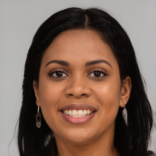 Joyful latino young-adult female with long  black hair and brown eyes
