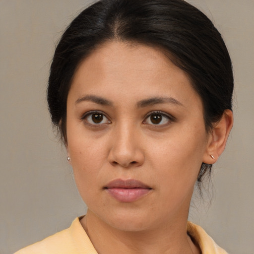 Joyful latino young-adult female with medium  brown hair and brown eyes