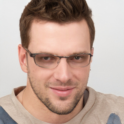 Joyful white adult male with short  brown hair and blue eyes