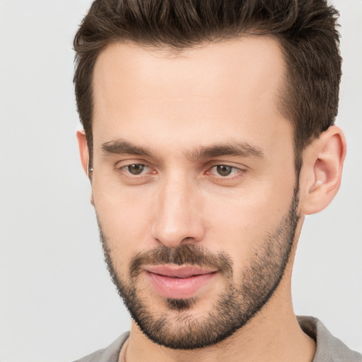 Joyful white young-adult male with short  brown hair and brown eyes